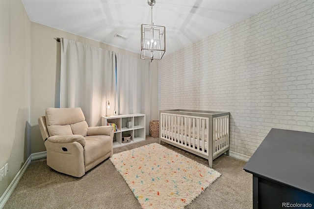 14589 Hagus Pl, Parker, CO 80134 - carpeted bedroom featuring a chandelier, brick wall, a crib, and baseboards