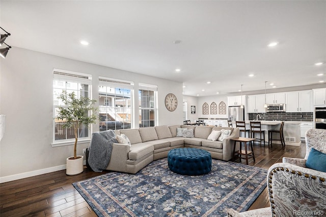 living room featuring dark wood-type flooring, recessed lighting, baseboards, and visible vents