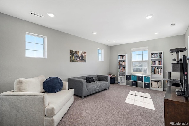 living room featuring recessed lighting, visible vents, and carpet floors