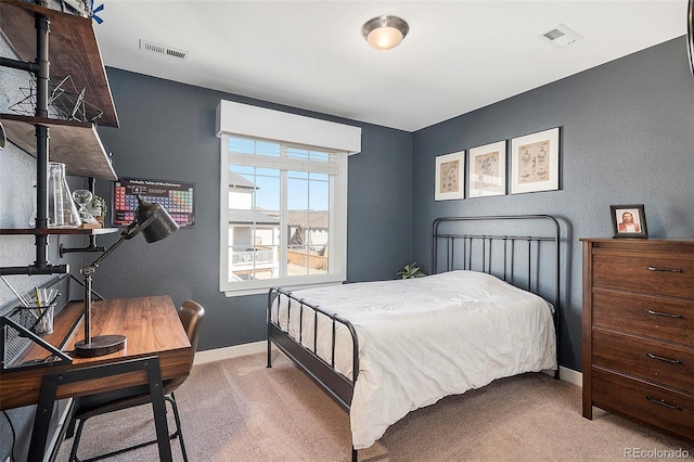 bedroom featuring visible vents, baseboards, and carpet