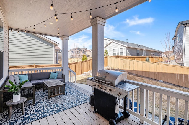 wooden terrace with an outdoor hangout area, fence, a residential view, and grilling area