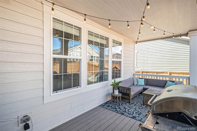 wooden terrace featuring a grill and outdoor lounge area