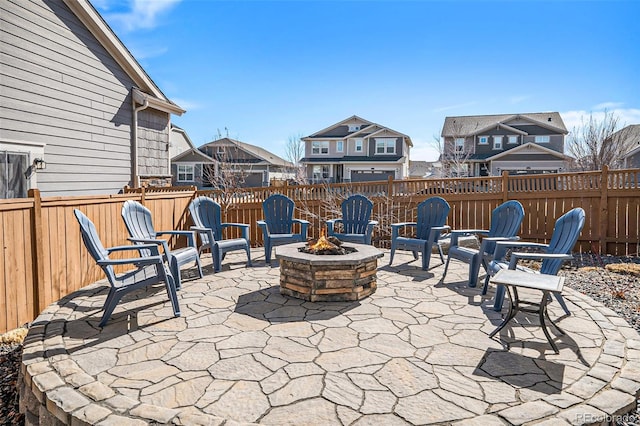 view of patio with a residential view, an outdoor fire pit, and fence