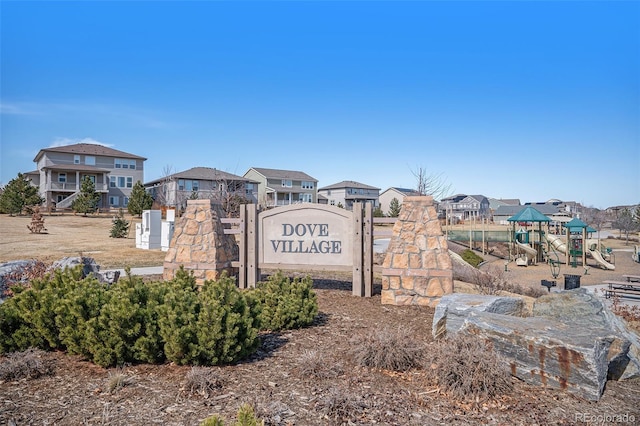 community / neighborhood sign with a residential view