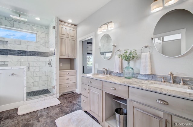 bathroom with a shower with shower door, tile patterned floors, and dual bowl vanity