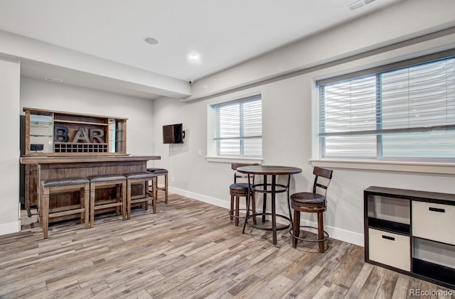 interior space featuring light hardwood / wood-style flooring and indoor bar