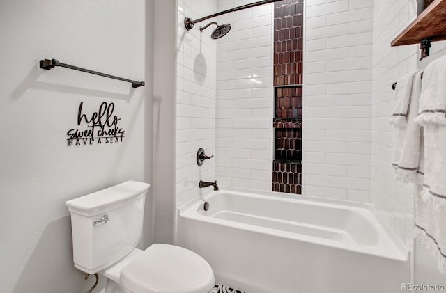 bathroom featuring tiled shower / bath combo and toilet