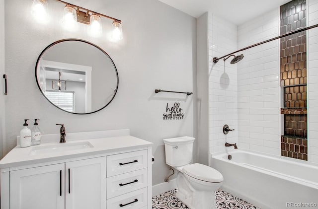 full bathroom with vanity, tile patterned flooring, tiled shower / bath, and toilet