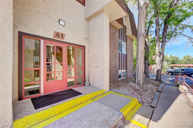 view of exterior entry featuring stucco siding