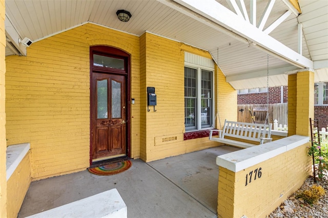 1776 S Logan St, Denver, CO 80210 - view of exterior entry with brick siding and a porch