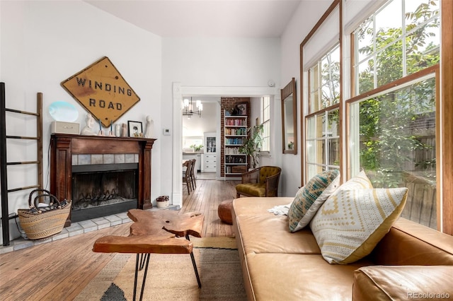 1776 S Logan St, Denver, CO 80210 - living room with hardwood / wood-style floors, a tile fireplace, and a chandelier