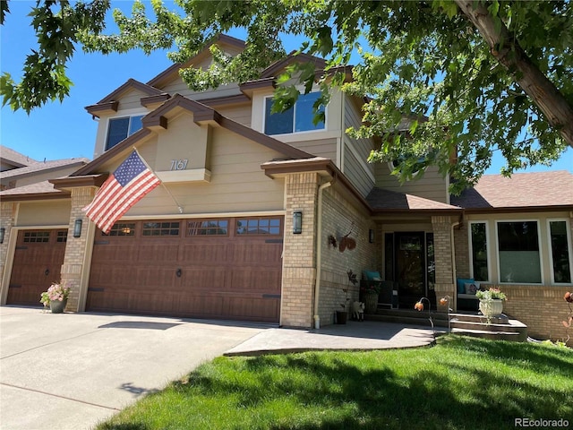 view of front of home featuring concrete driveway, brick siding, a garage, and a front lawn