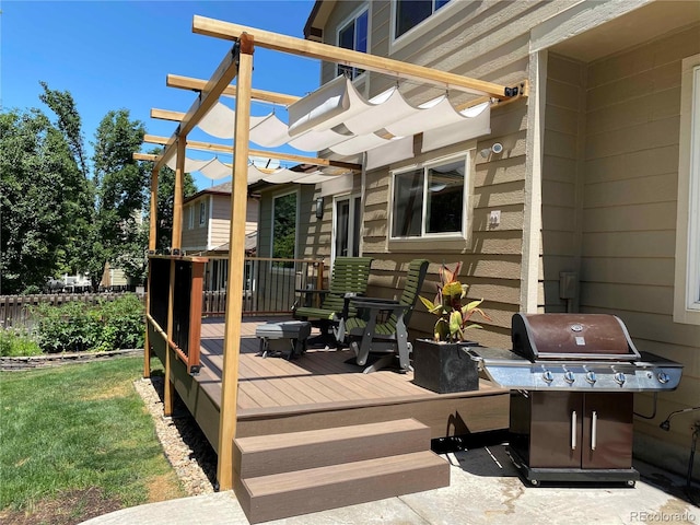 deck featuring area for grilling, a pergola, and a lawn