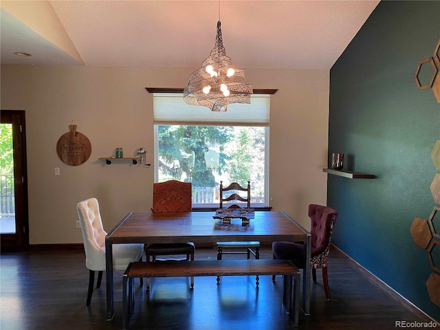 dining room with a healthy amount of sunlight, wood finished floors, a notable chandelier, and baseboards