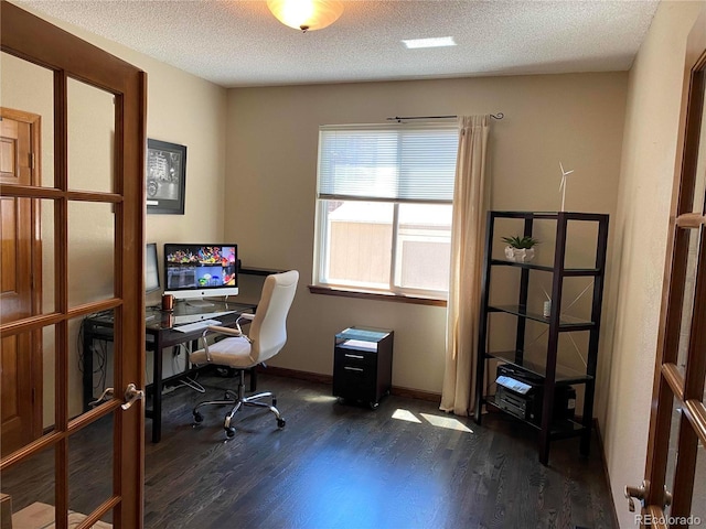 office space with a textured ceiling, wood finished floors, and baseboards