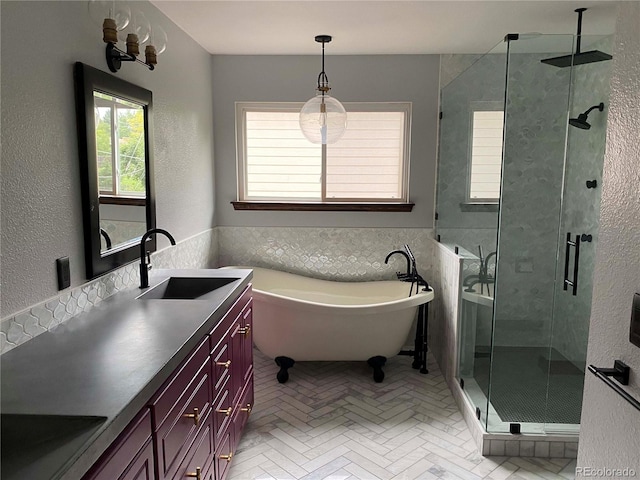 bathroom with vanity, a soaking tub, a wainscoted wall, a shower stall, and tile walls