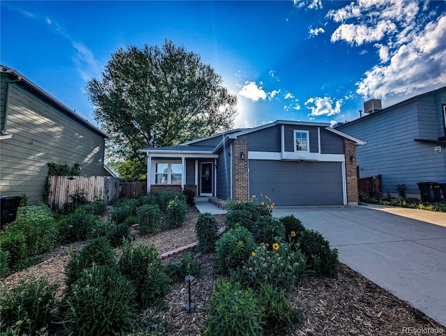 6365 Xavier Ct, Arvada, CO 80003 - view of front of house featuring brick siding, concrete driveway, and a garage