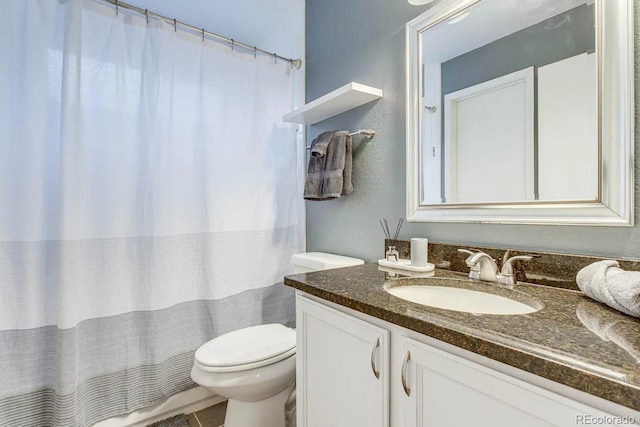 6365 Xavier Ct, Arvada, CO 80003 - bathroom featuring toilet, vanity, a textured wall, and a shower with curtain