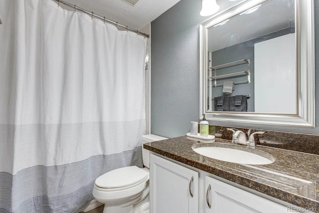 6365 Xavier Ct, Arvada, CO 80003 - full bathroom with a textured wall, vanity, toilet, and a shower with curtain