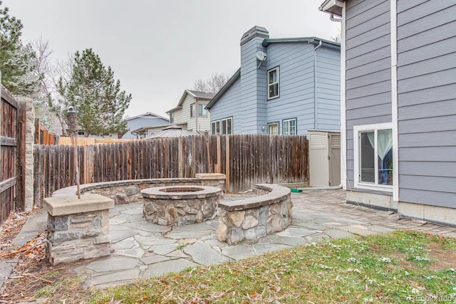 6365 Xavier Ct, Arvada, CO 80003 - fenced backyard featuring an outdoor fire pit and a patio