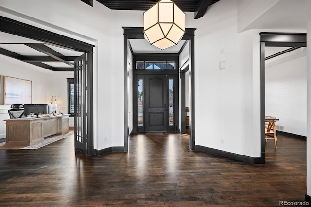 foyer entrance featuring dark wood-style floors, beam ceiling, coffered ceiling, and baseboards