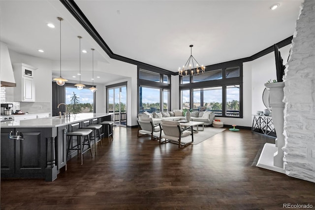 dining room featuring dark wood-style floors, ornamental molding, and a wealth of natural light