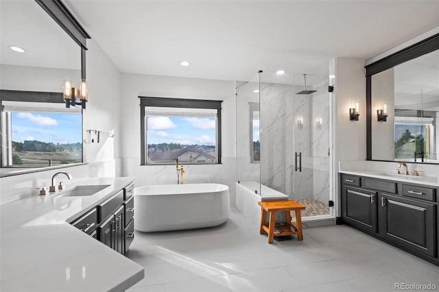 full bath featuring recessed lighting, vanity, tile walls, a soaking tub, and a marble finish shower