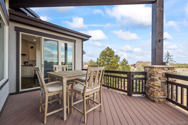 wooden terrace with outdoor dining area