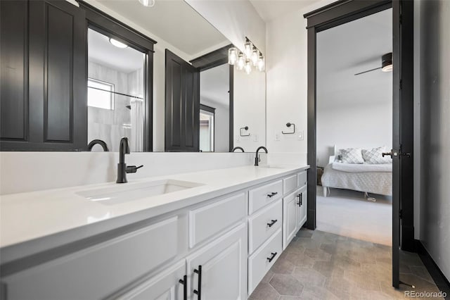 ensuite bathroom featuring ensuite bathroom, double vanity, ceiling fan, and a sink