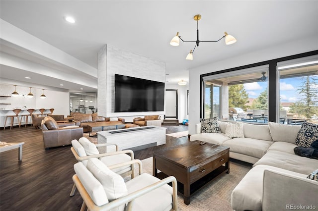 living area with wood finished floors and recessed lighting