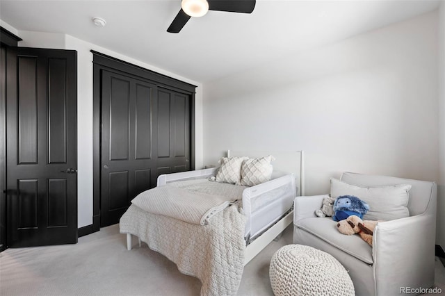 bedroom with a closet, light carpet, and ceiling fan