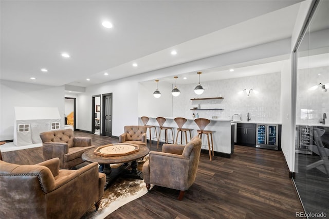 living area with baseboards, dark wood finished floors, wine cooler, wet bar, and recessed lighting