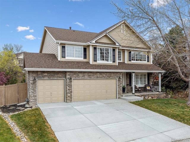 view of front of house with an attached garage, fence, a shingled roof, a porch, and driveway