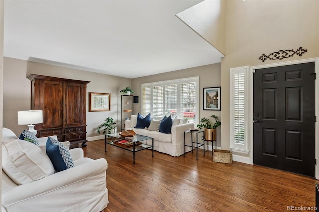 living room with plenty of natural light, wood finished floors, and baseboards