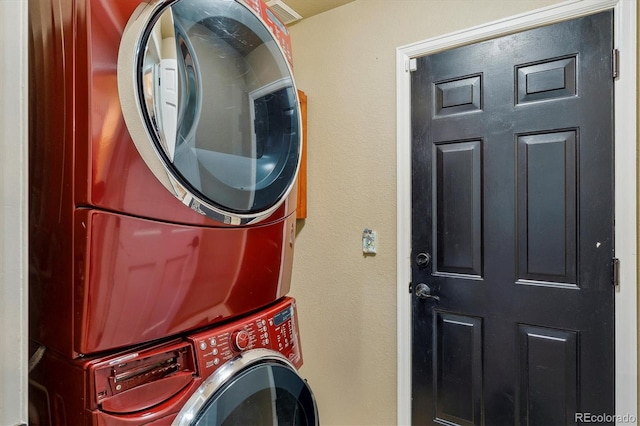 laundry room with stacked washer and dryer and laundry area