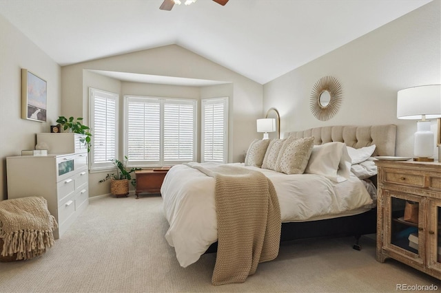 bedroom with ceiling fan, lofted ceiling, and carpet floors