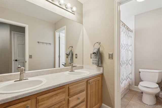 bathroom with toilet, tile patterned flooring, double vanity, and a sink