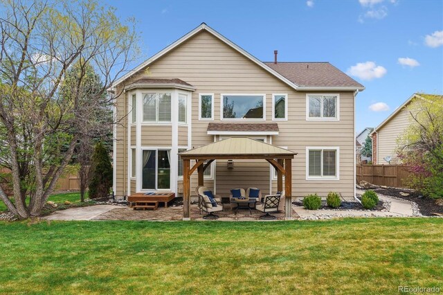 back of house with outdoor lounge area, fence, a lawn, a gazebo, and a patio area