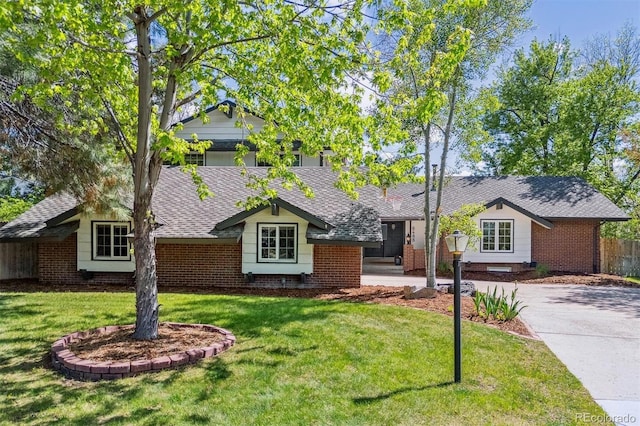 6488 S Heritage Pl E, Centennial, CO 80111 - view of front of property with a front lawn, roof with shingles, and brick siding