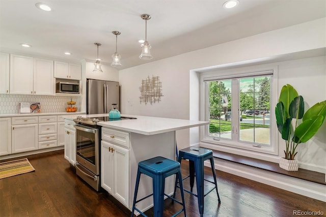 6488 S Heritage Pl E, Centennial, CO 80111 - kitchen with appliances with stainless steel finishes, white cabinets, light countertops, dark wood-style floors, and recessed lighting