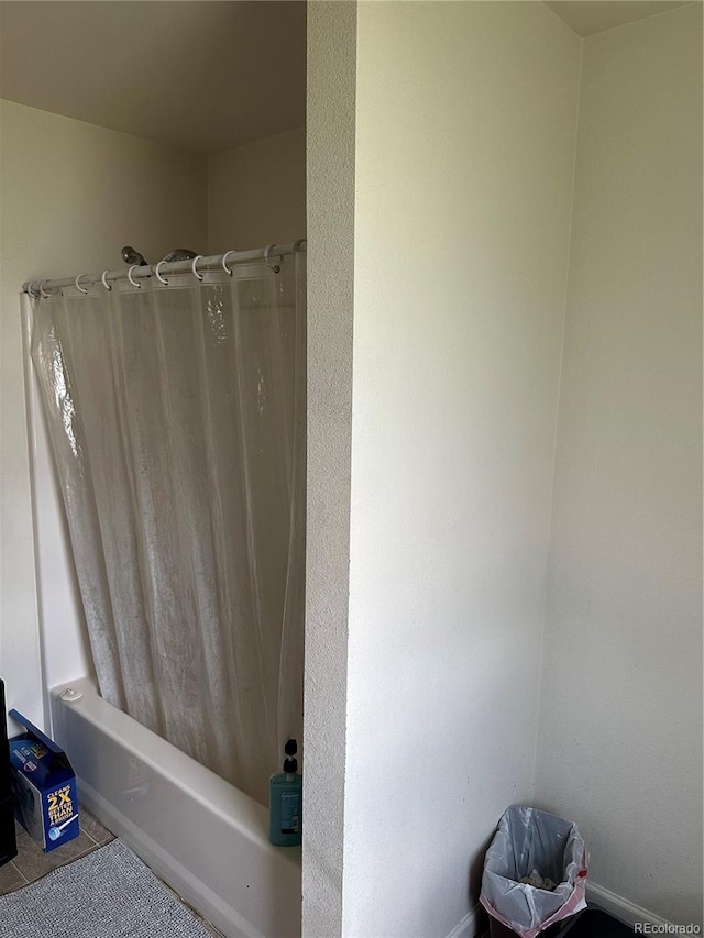 bathroom with tile patterned floors and shower / tub combo with curtain