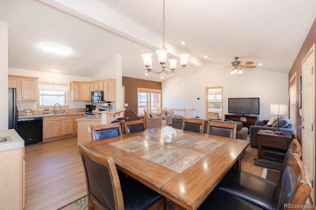 dining area featuring sink, ceiling fan with notable chandelier, vaulted ceiling with beams, and light wood-type flooring