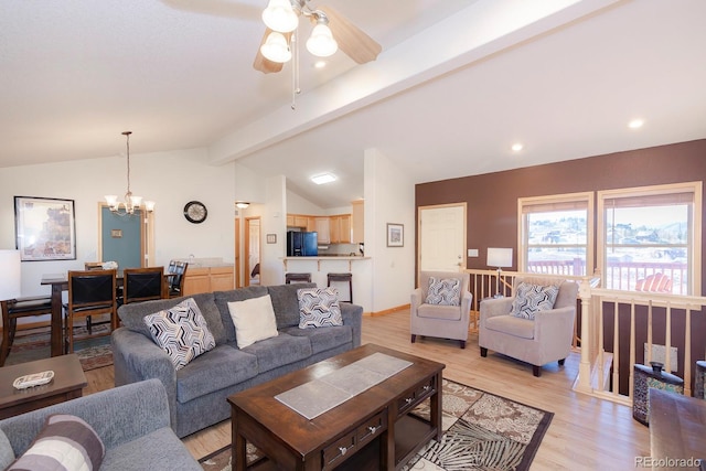 living room featuring vaulted ceiling with beams, ceiling fan with notable chandelier, and light hardwood / wood-style flooring