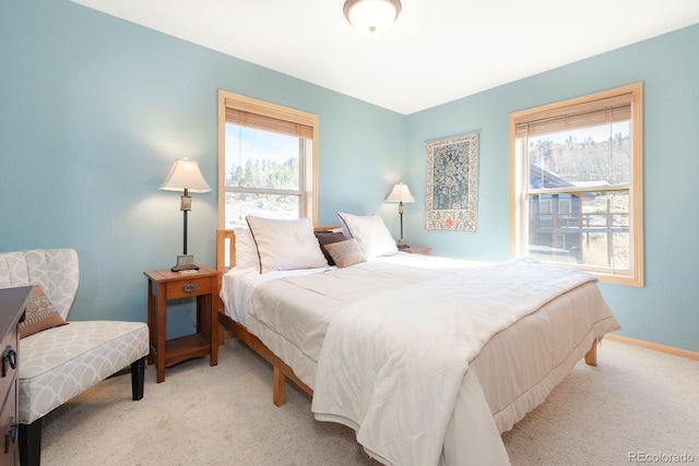 carpeted bedroom featuring multiple windows