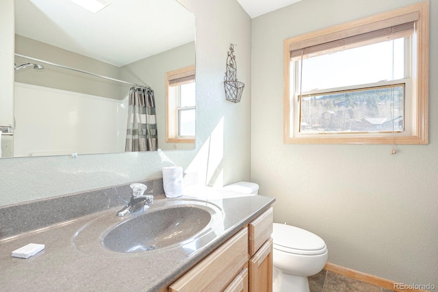 bathroom featuring walk in shower, vanity, and toilet