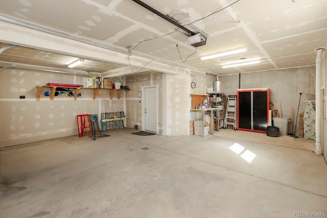 garage featuring a garage door opener and a workshop area