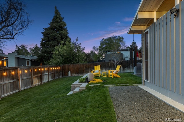 view of yard featuring a fenced backyard and central AC
