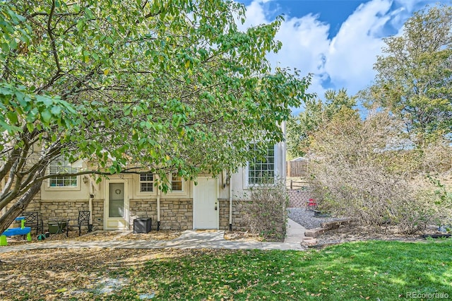 obstructed view of property with a front lawn