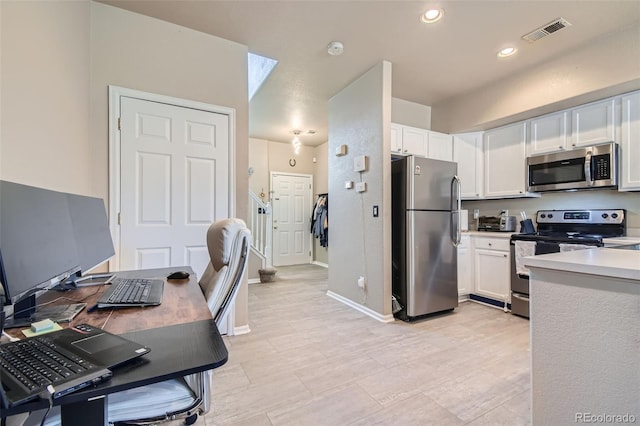 kitchen featuring appliances with stainless steel finishes and white cabinetry