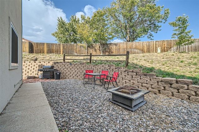 exterior space featuring an outdoor fire pit and a patio area